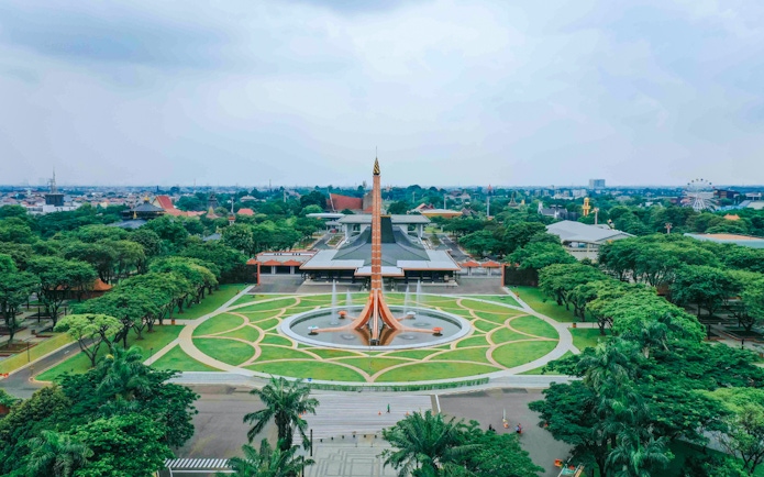 Aerial view of Taman Mini Indonesia, Jakarta, showcasing the central monument and surrounding greenery.