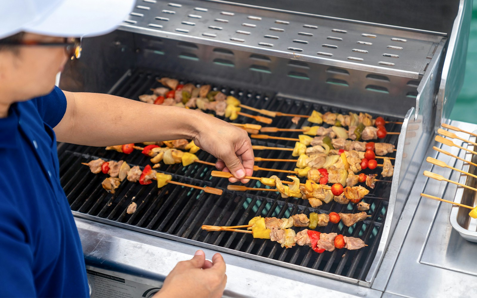 Grilling skewers with vegetables and meat at Dubai Marina yacht party BBQ.