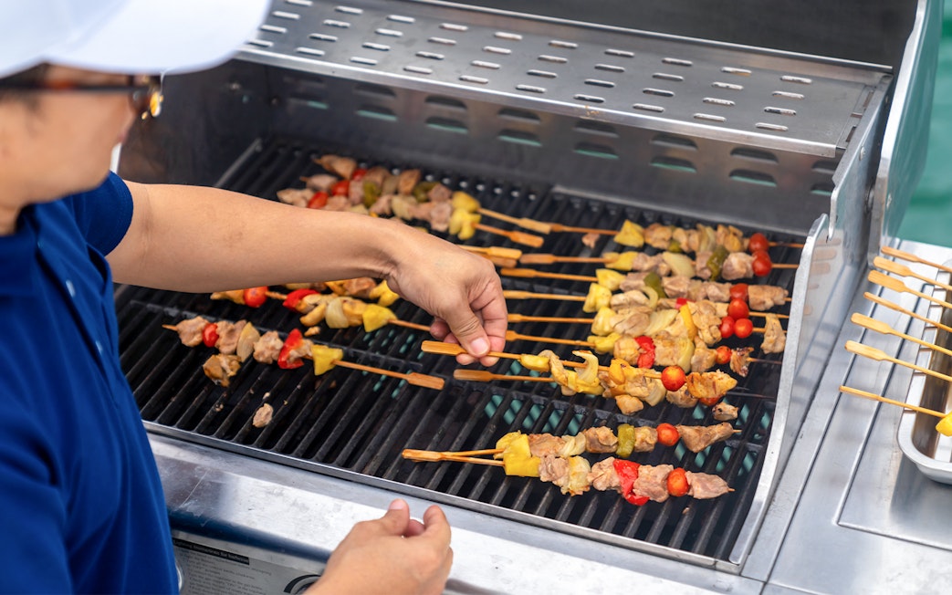 Grilling skewers with vegetables and meat at Dubai Marina yacht party BBQ.