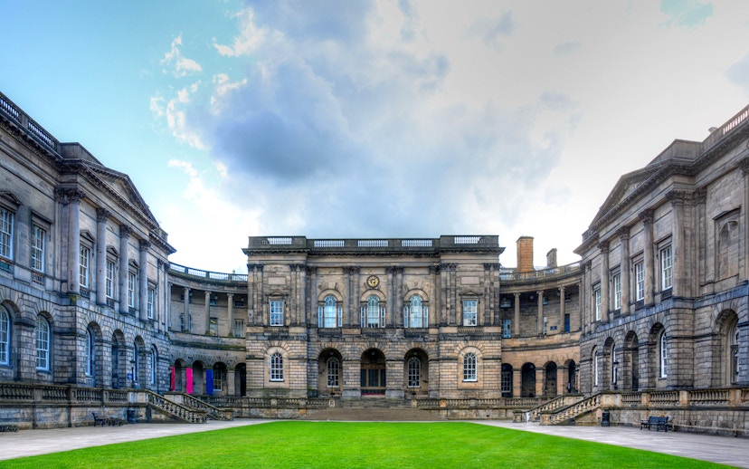 Courtyard of the University of Edinburgh, Scotland, with historic stone buildings.