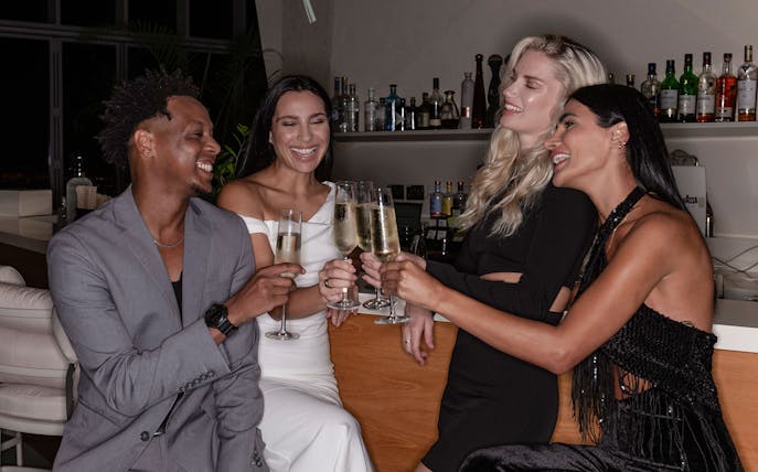 Group enjoying drinks at a bar near Aura Sky Pool.