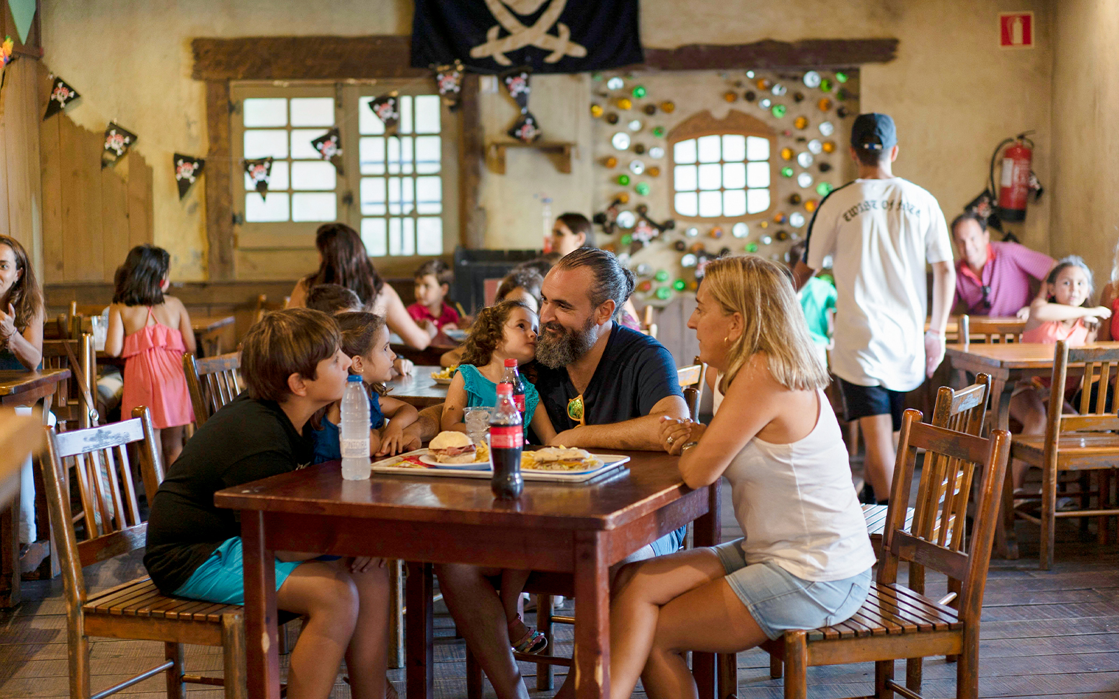 Family dining at Isla Mágica restaurant with pirate-themed decor.