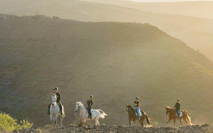 Horseback riders on volcanic trail in Gran Canaria.