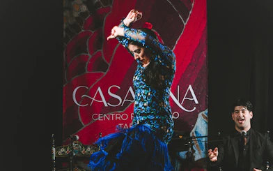 Flamenco dancer performing at Casa Ana Flamenco Show with a singer in the background.