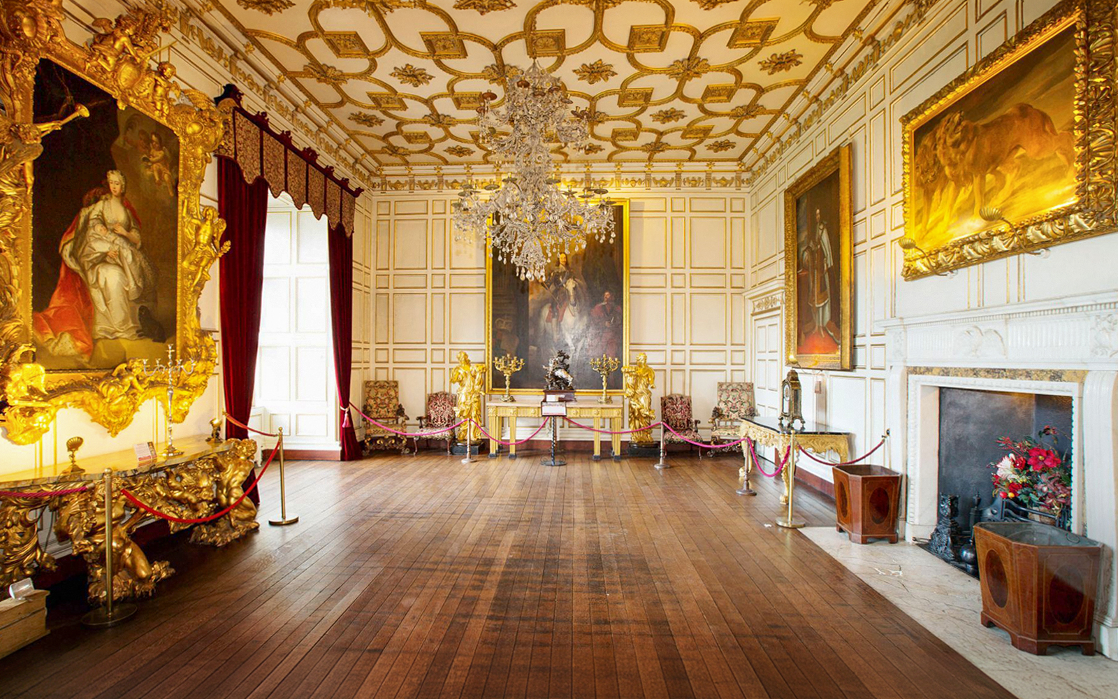 Warwick Castle interior with ornate paintings and chandelier on Stratford, Oxford, Cotswolds tour.
