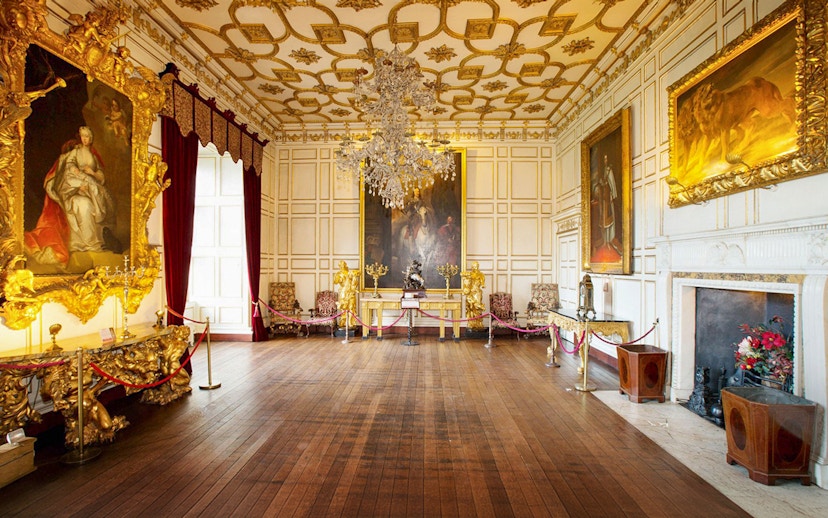 Warwick Castle interior with ornate paintings and chandelier on Stratford, Oxford, Cotswolds tour.