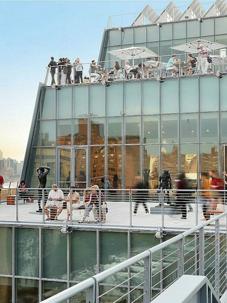 Whitney Museum of American Art terrace with visitors overlooking New York City skyline.
