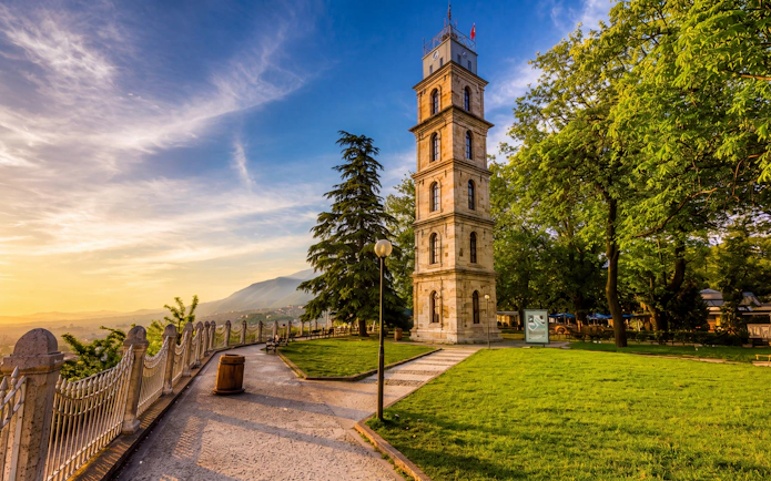 Tophane Viewpoint with historic clock tower and scenic city view at sunset.