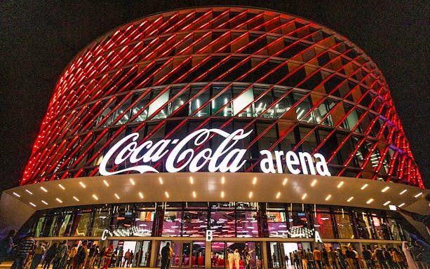 Coca-Cola Arena exterior lit up at night, Dubai, venue for Rewind Reloaded Live.