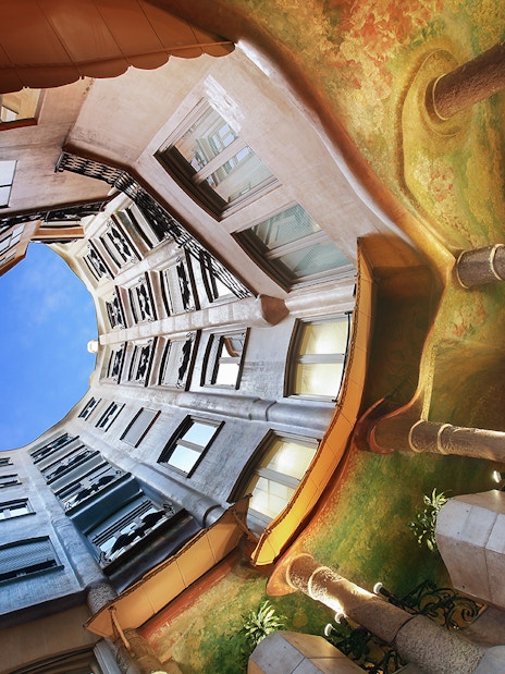 La Pedrera's interior courtyard with unique architecture and open sky view in Barcelona.