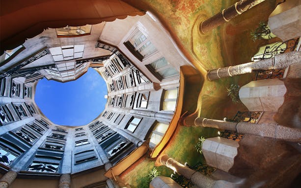 La Pedrera's interior courtyard with unique architecture and open sky view in Barcelona.