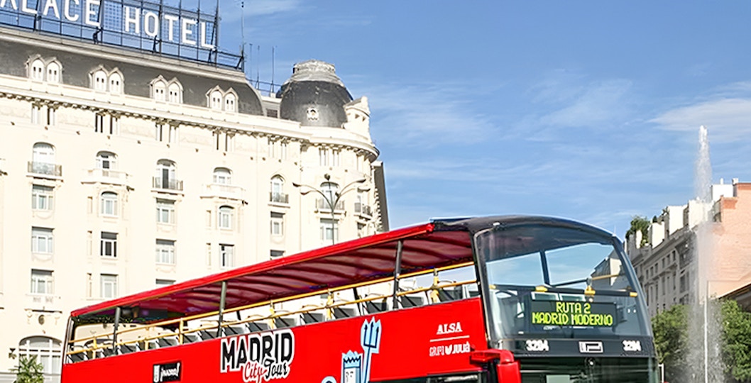 Madrid cityscape with iconic landmarks viewed from a hop-on-hop-off tour bus.