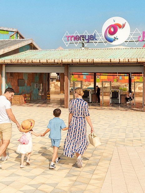 Visitors entering Meryal Waterpark through colorful entrance.