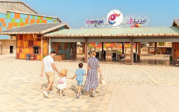 Visitors entering Meryal Waterpark through colorful entrance.