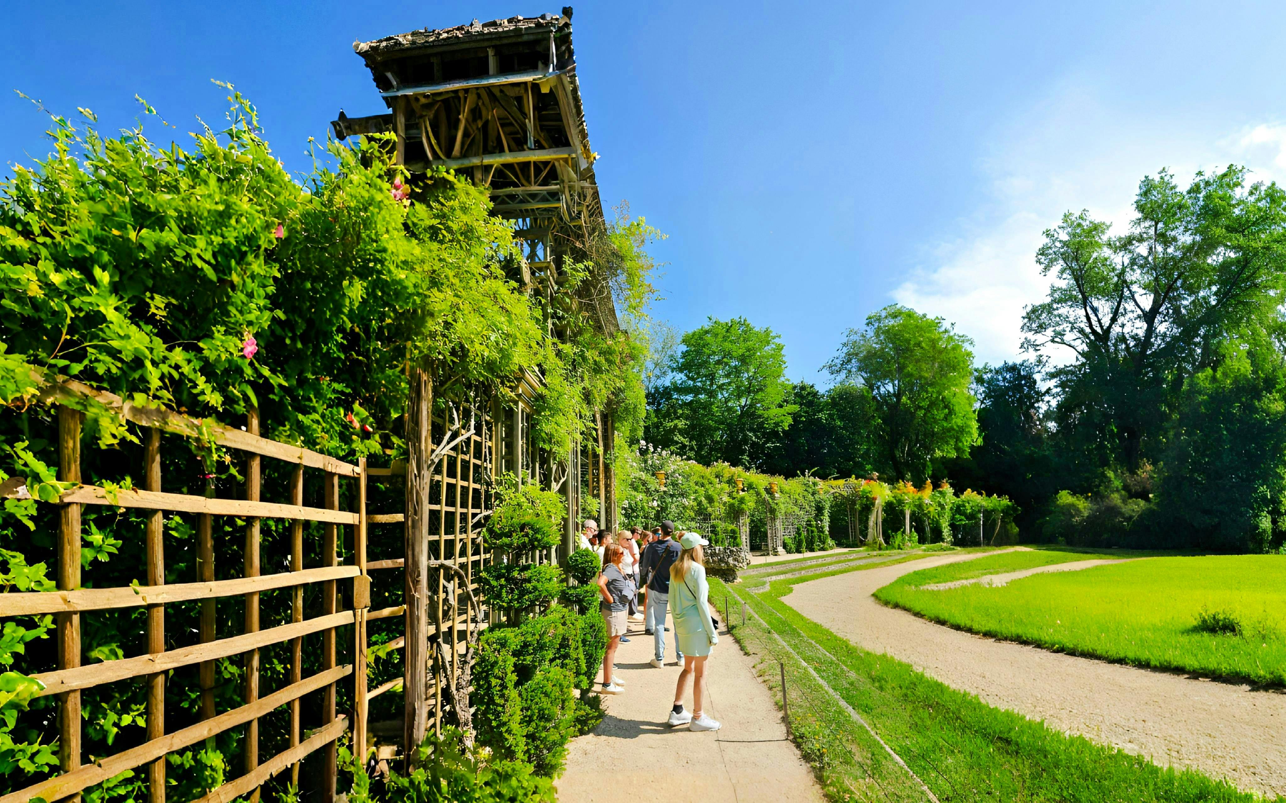 Visitors exploring gardens on the Versailles Golfcart & Bike Guided Tour.