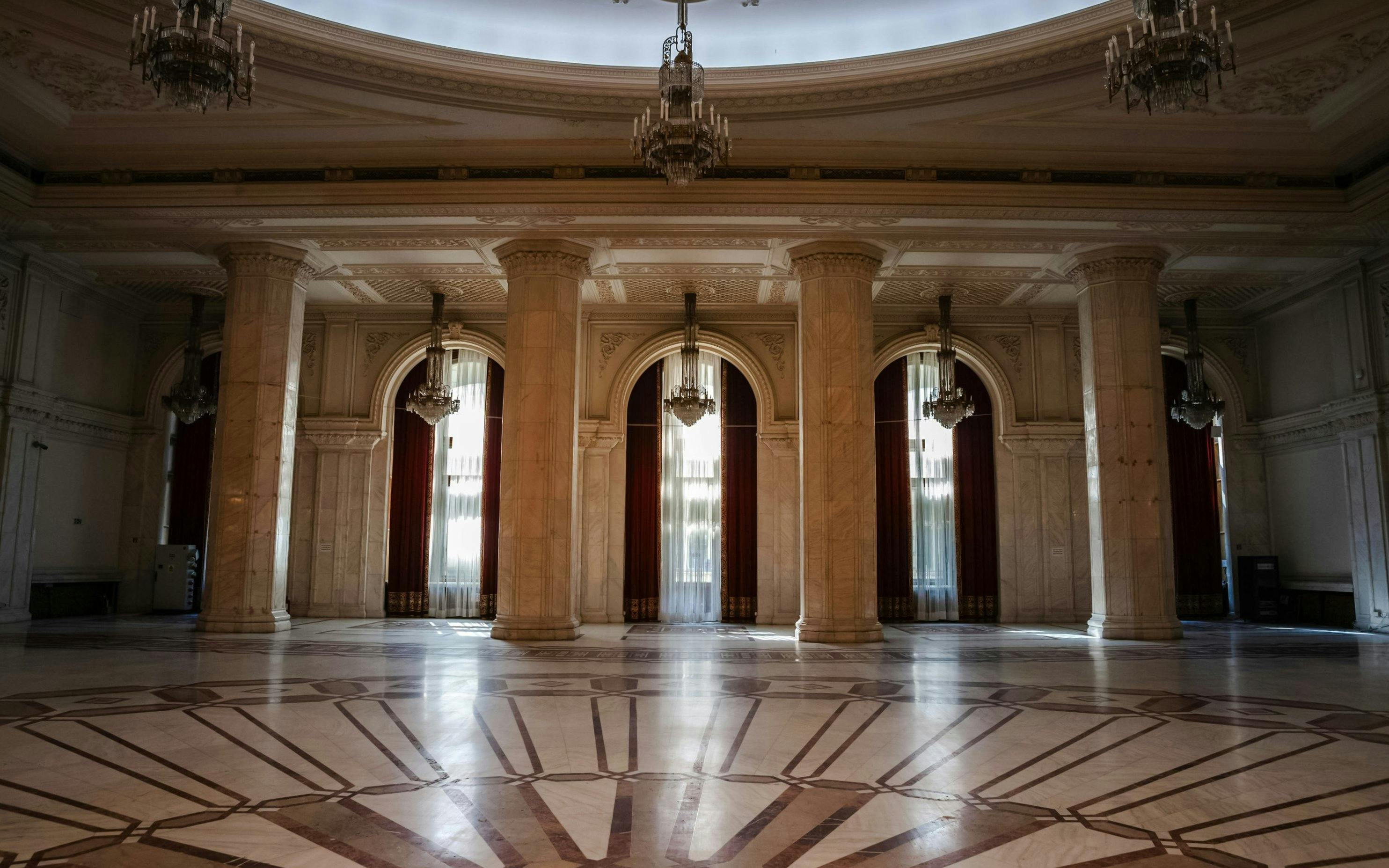 Grand marble hall with chandeliers inside Palace of Parliament, Bucharest, Romania.