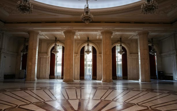 Grand marble hall with chandeliers inside Palace of Parliament, Bucharest, Romania.