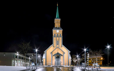 Tromsø Cathedral illuminated at night, venue for Arctic Music Experience concert.