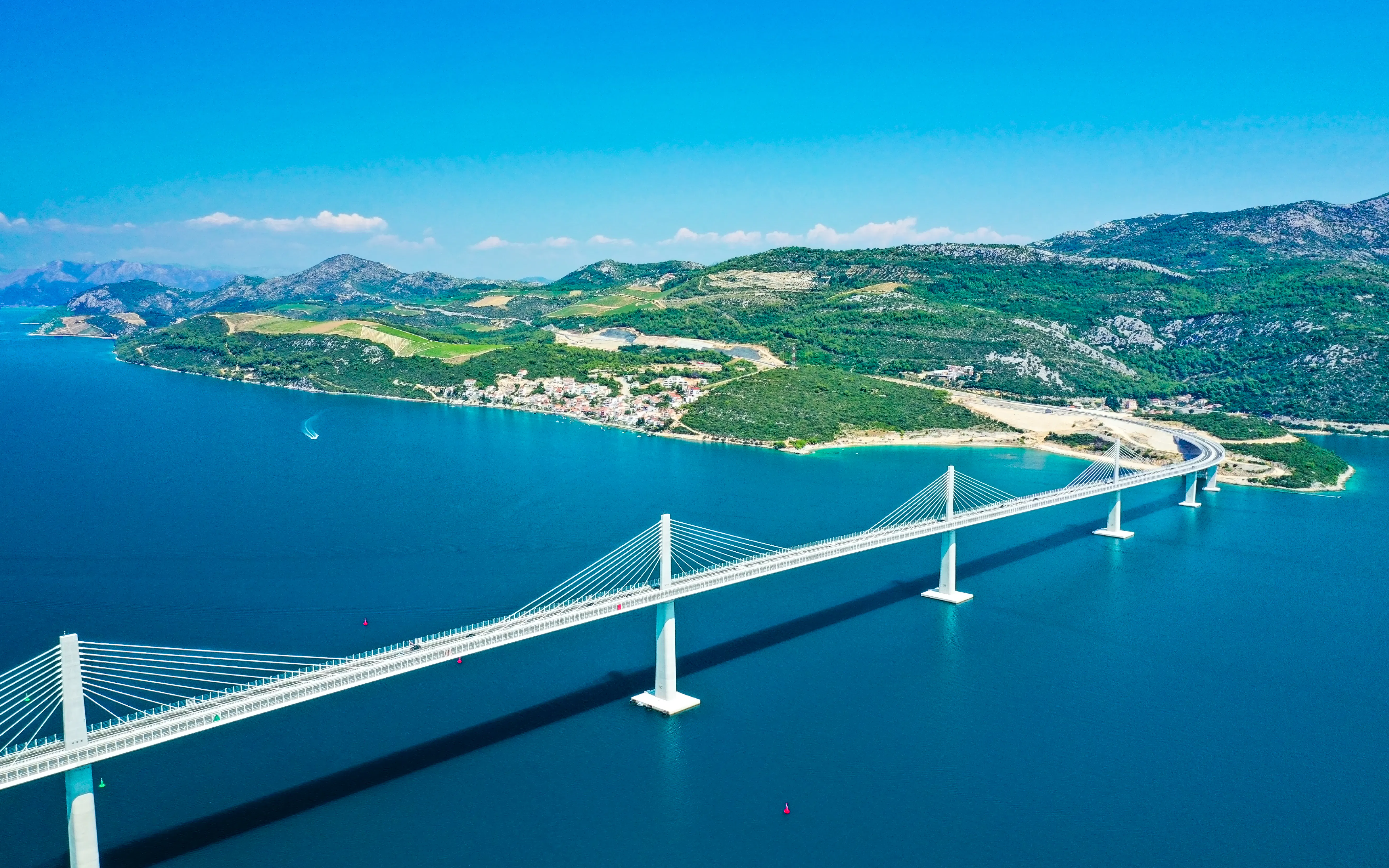 Aerial view of Pelješac Bridge spanning blue waters in Croatia.