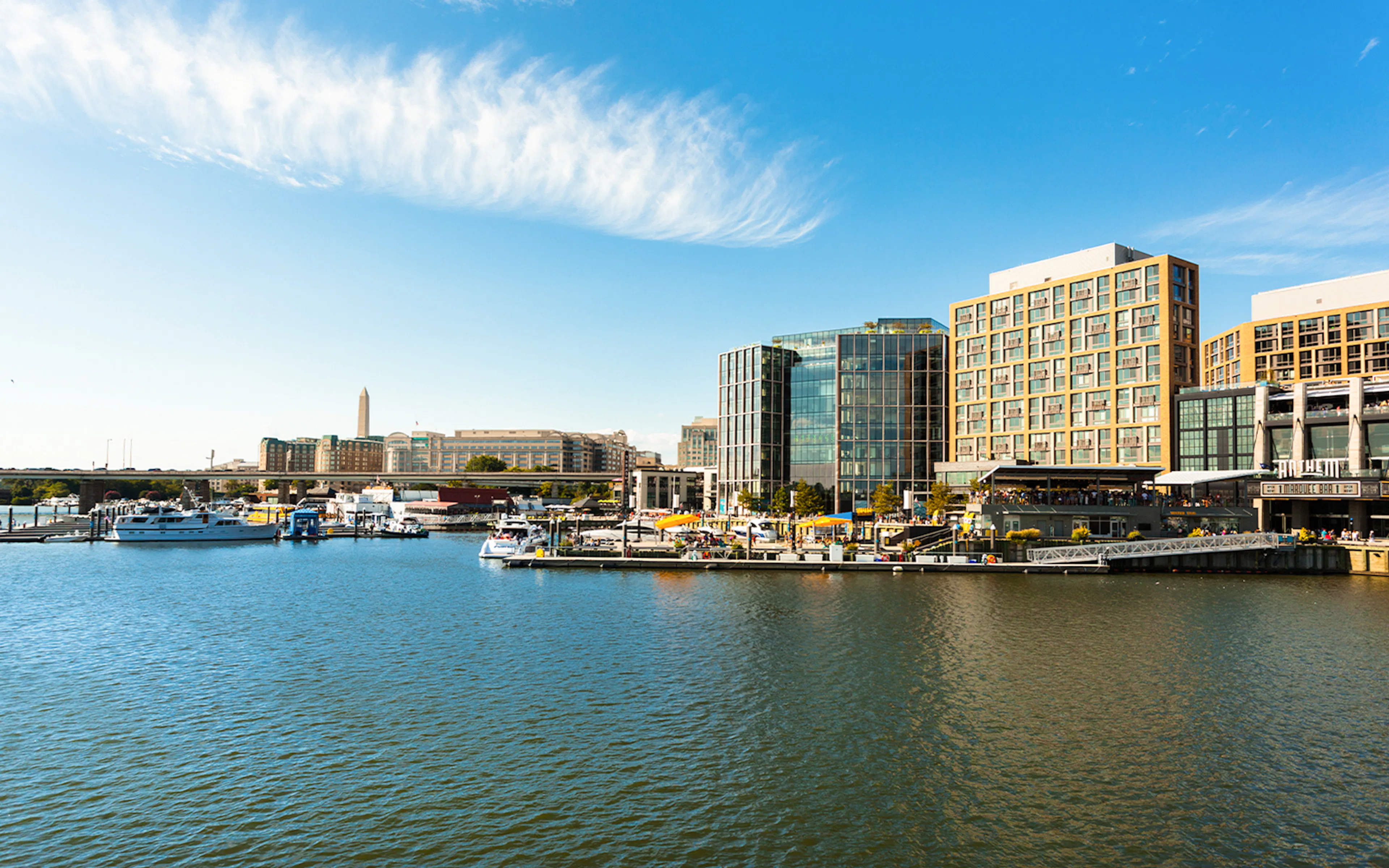 Waterfront view with boats and modern buildings on a sunny day in Washington, USA.