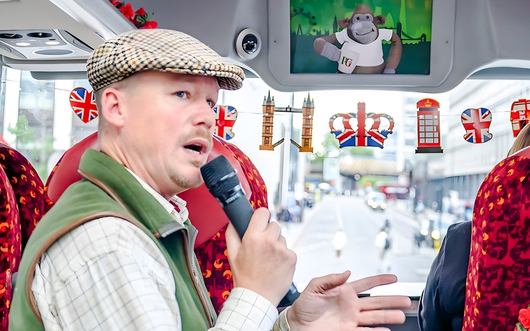 Tour guide speaking on Afternoon Tea Sightseeing Bus Tour in London.