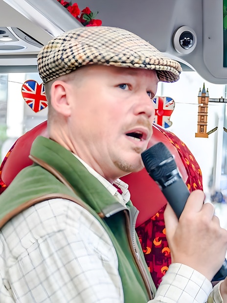 Tour guide speaking on Afternoon Tea Sightseeing Bus Tour in London.