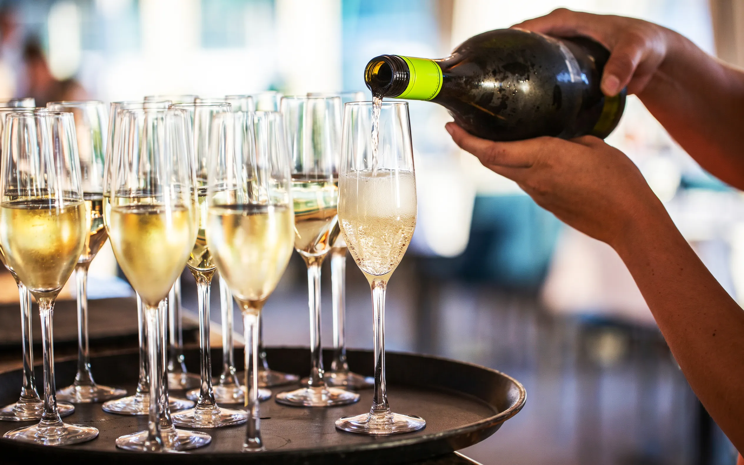 Prosecco being poured into glasses on Budapest Danube River cruise.