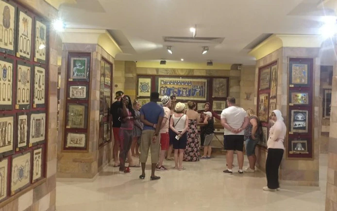 Tourists exploring an art gallery with a private guide in Hurghada.