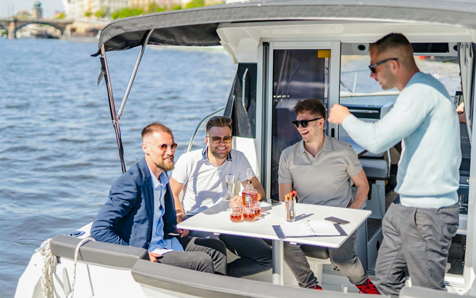 Group of friends enjoying Prosecco on a speed boat in Prague.