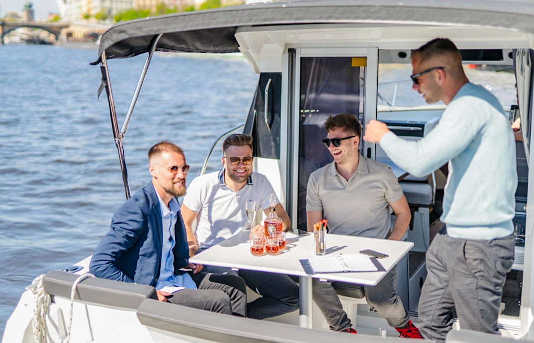 Group of friends enjoying Prosecco on a speed boat in Prague.