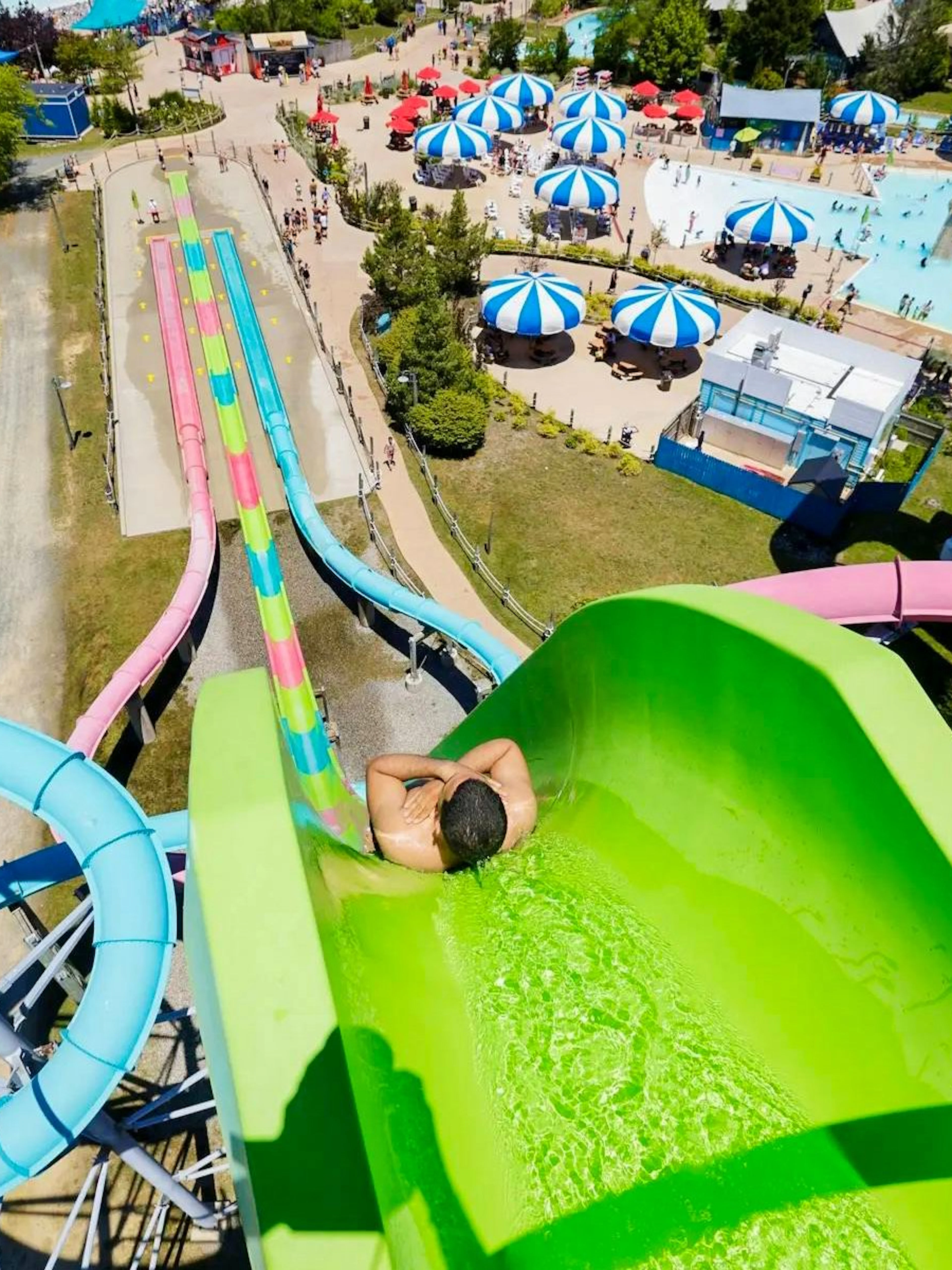 Water slide at Hurricane Harbor New Jersey with colorful tubes and pool area.