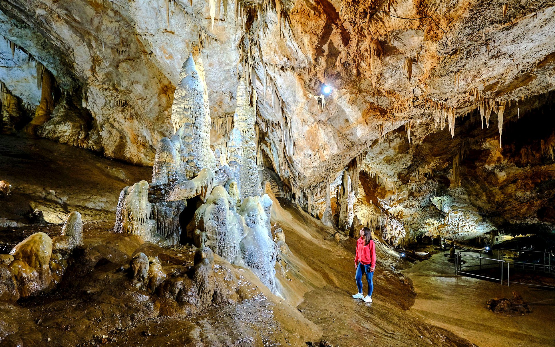 Tourist exploring stalagmites inside Lipa Cave, Cetinje.