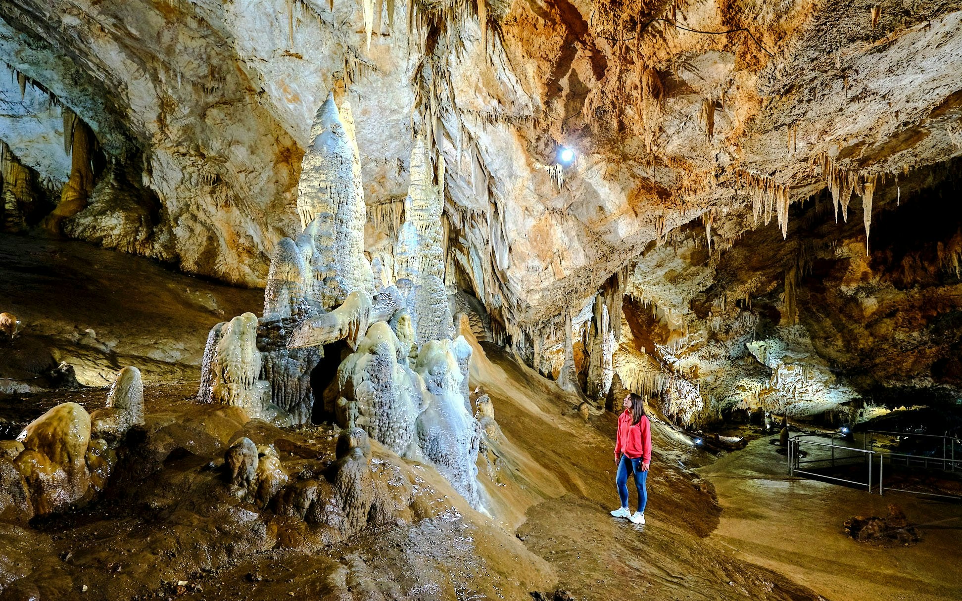 Tourist exploring stalagmites inside Lipa Cave, Cetinje.
