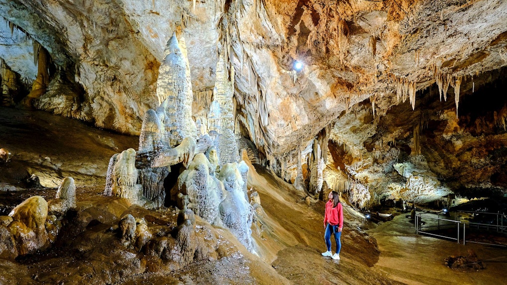 Tourist exploring stalagmites inside Lipa Cave, Cetinje.