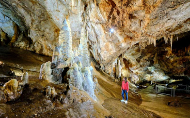 Tourist exploring stalagmites inside Lipa Cave, Cetinje.