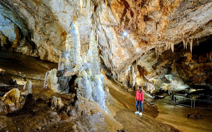 Tourist exploring stalagmites inside Lipa Cave, Cetinje.
