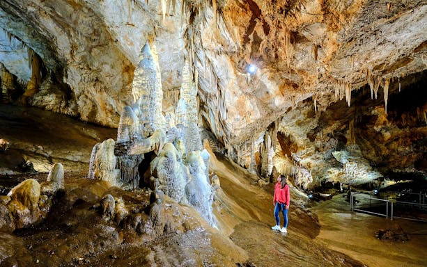 Tourist exploring stalagmites inside Lipa Cave, Cetinje.
