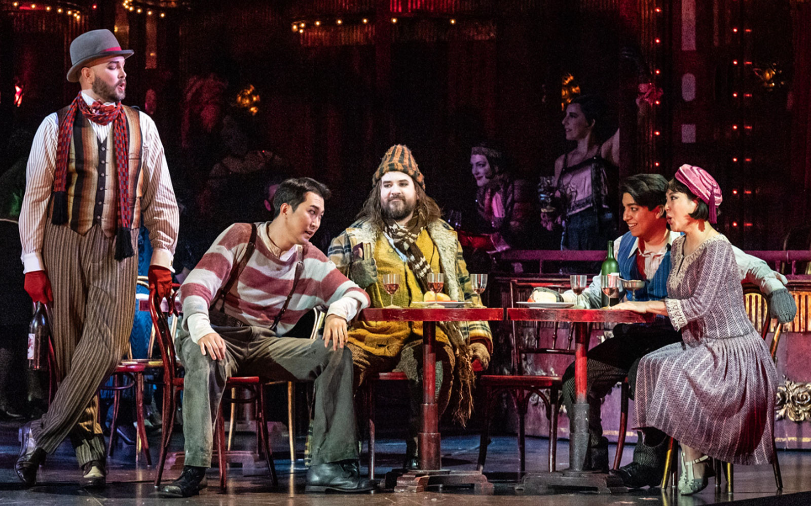 Opera performers in a lively café scene from La Bohème.