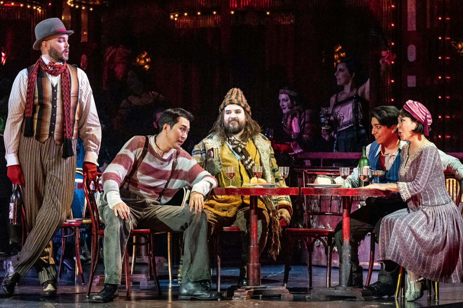 Opera performers in a lively café scene from La Bohème.