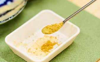 Kintsugi gold powder on a spoon at a workshop in Shinjuku, Tokyo.