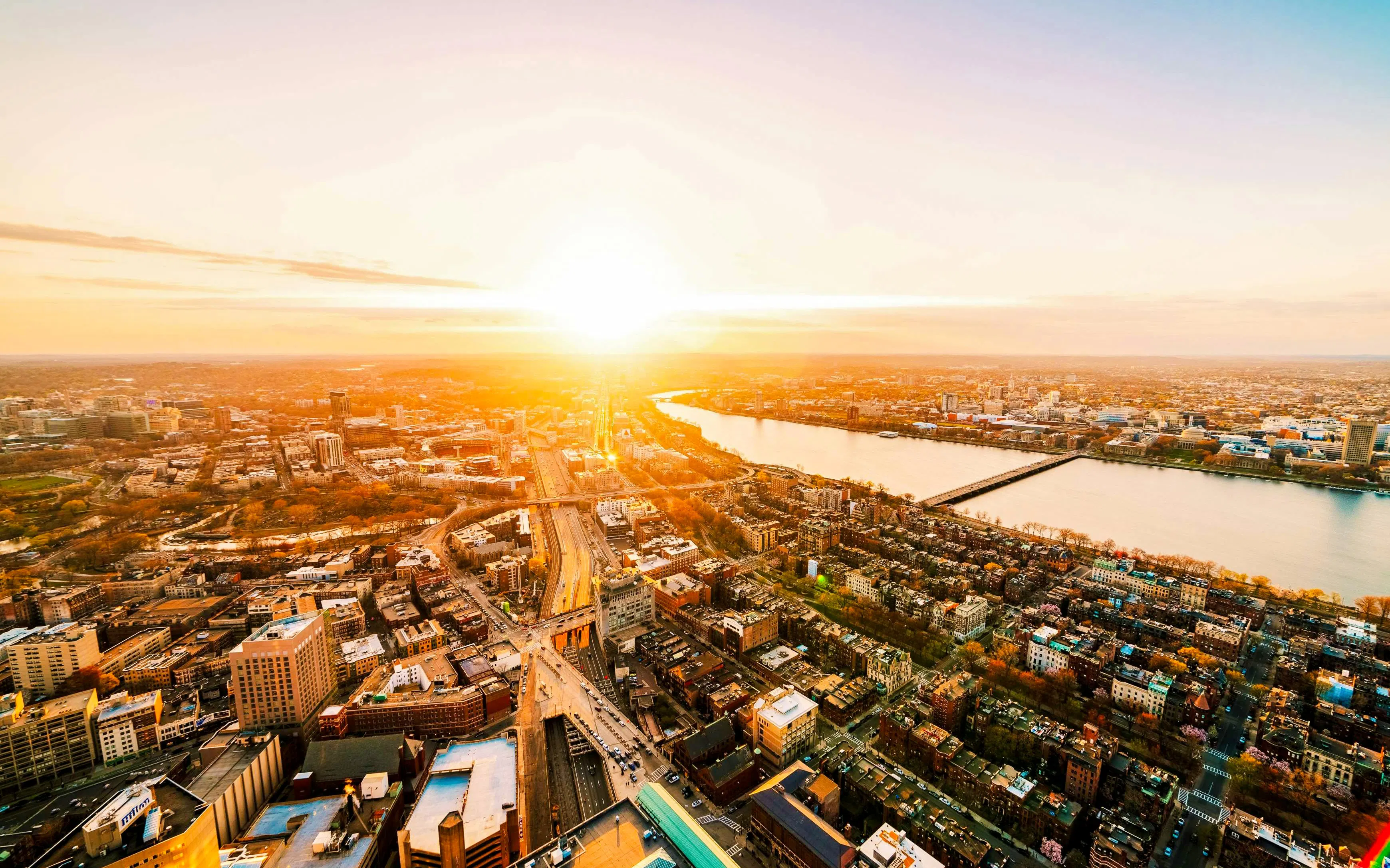 Aerial view of Boston skyline at sunset with Charles River.