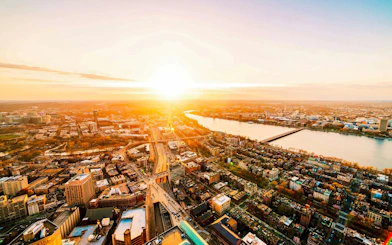 Aerial view of Boston skyline at sunset with Charles River.