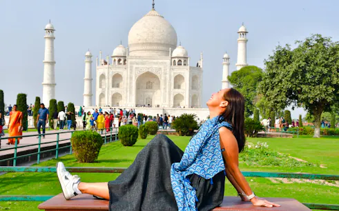 Visitor relaxing in front of the Taj Mahal during a sunrise tour in Agra.