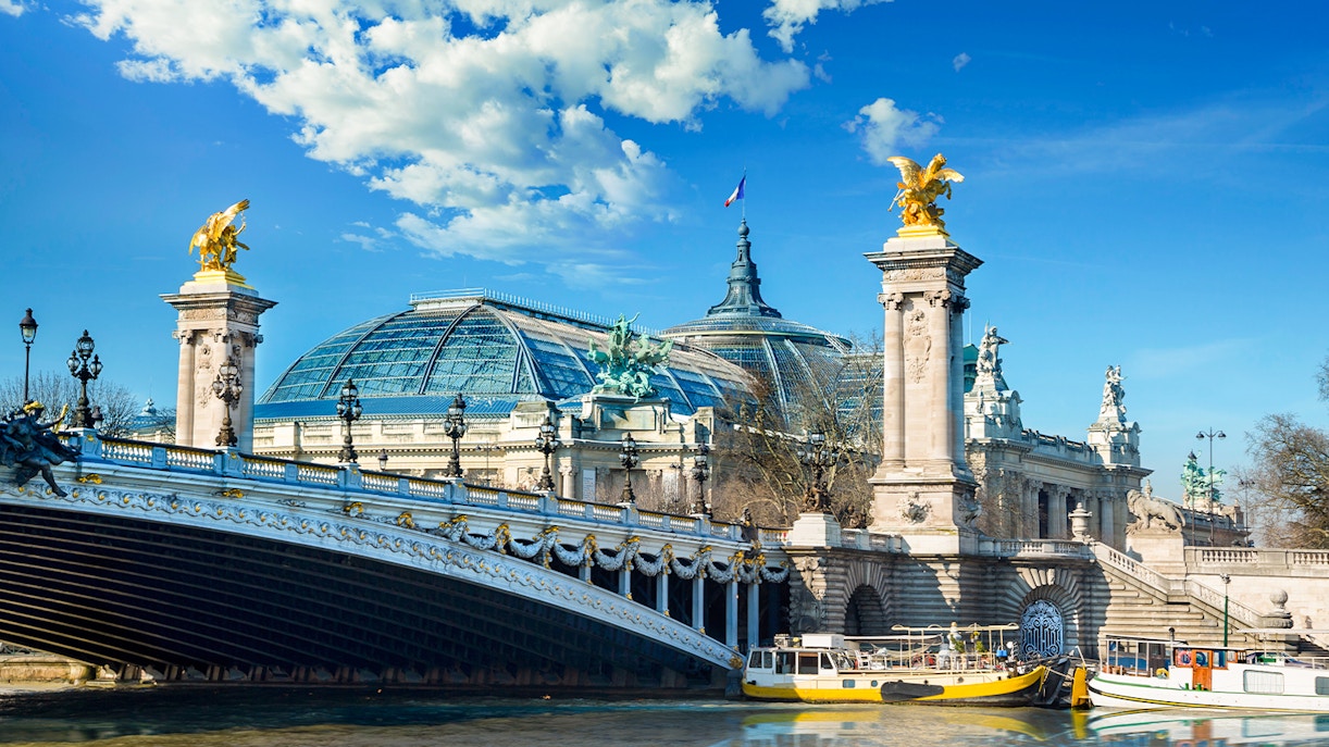 Pont Alexandre III and Grand Palais viewed from a Seine River cruise in Paris.
