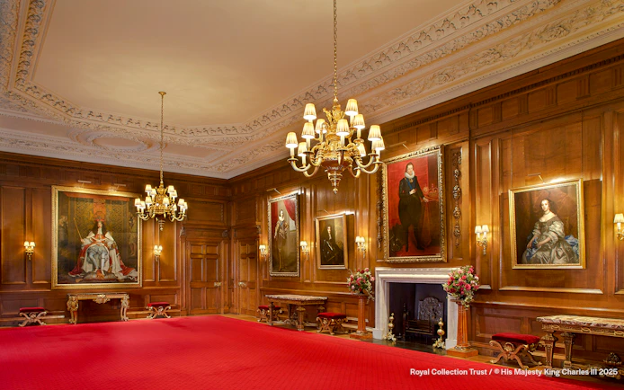 Throne Room at the Palace of Holyroodhouse with portraits and ornate chandelier.
