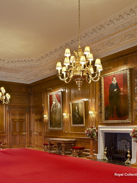 Throne Room at the Palace of Holyroodhouse with portraits and ornate chandelier.
