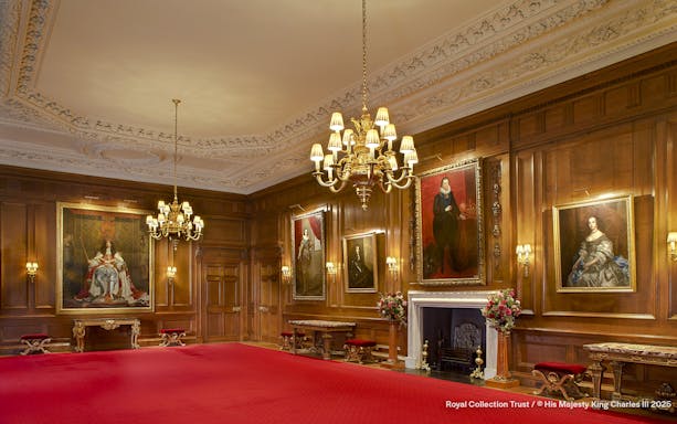 Throne Room at the Palace of Holyroodhouse with portraits and ornate chandelier.