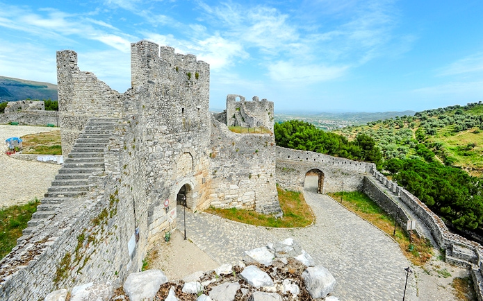 Berat Castle stone walls and towers with scenic hillside view in Albania.