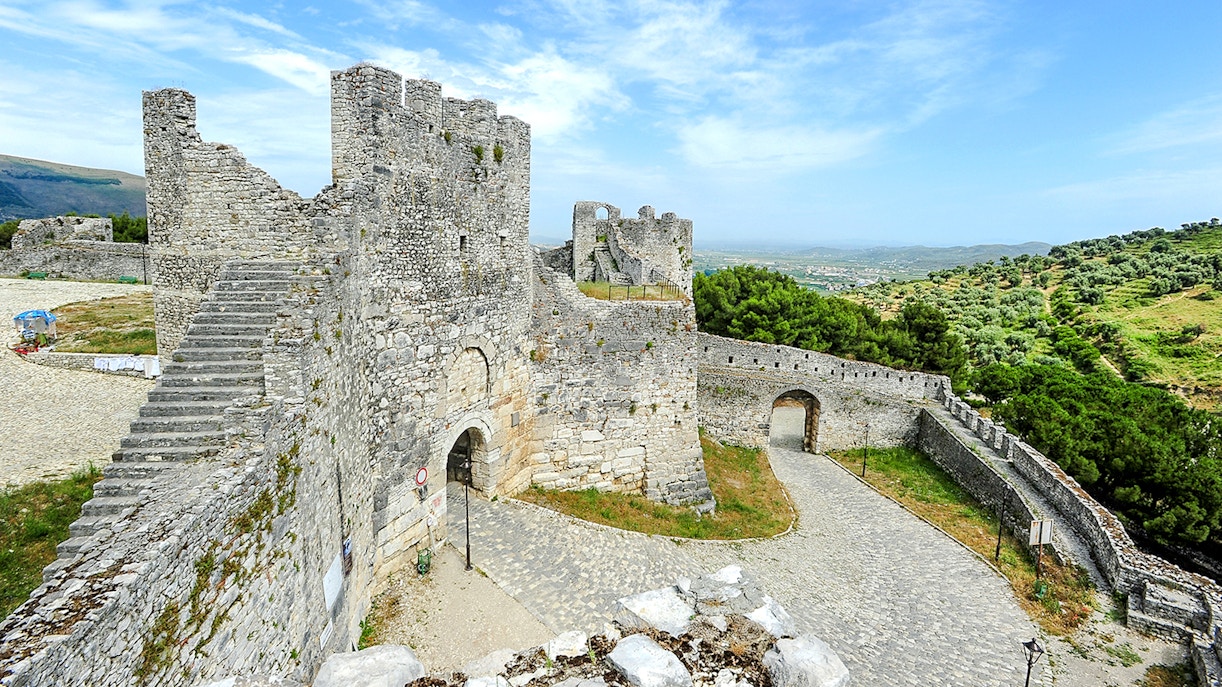 Berat Castle stone walls and towers with scenic hillside view in Albania.