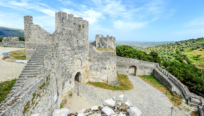 Berat Castle stone walls and towers with scenic hillside view in Albania.